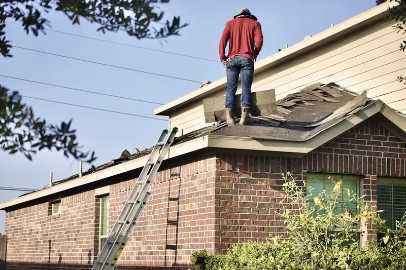 Professional roofer working on a residential roof in Ferncroft